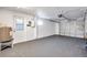 Attached garage with overhead door and light grey floor at 5700 Marble Dr, New Port Richey, FL 34652