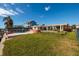 The backyard features a pool, lush lawn, and waterfront access, perfect for outdoor enjoyment at 825 116Th Ave, Treasure Island, FL 33706