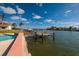 Waterfront property featuring a private dock with boat lift, pool and beautiful canal views at 825 116Th Ave, Treasure Island, FL 33706