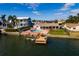 Waterfront home with a pool, boat dock, and lush landscaping in a desirable community at 825 116Th Ave, Treasure Island, FL 33706