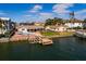 Waterfront home featuring a private pool, boat dock, and lush landscaping at 825 116Th Ave, Treasure Island, FL 33706