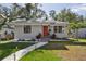 Gray house with red front door, walkway, and well-manicured lawn at 946 23Rd S Ave, St Petersburg, FL 33705