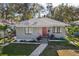 Gray house with red door, landscaping, and walkway at 946 23Rd S Ave, St Petersburg, FL 33705
