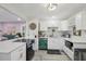 Modern white kitchen with a breakfast bar and stainless steel appliances at 946 23Rd S Ave, St Petersburg, FL 33705