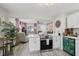 Modern white kitchen with island, stainless steel appliances, and stylish backsplash at 946 23Rd S Ave, St Petersburg, FL 33705
