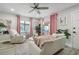 Bright living room with white sofa, pink accents, and ceiling fan at 946 23Rd S Ave, St Petersburg, FL 33705