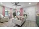 Bright living room with white sofa, pink accents, and ceiling fan at 946 23Rd S Ave, St Petersburg, FL 33705