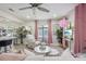 Bright living room with white sofa, pink accents, and ceiling fan at 946 23Rd S Ave, St Petersburg, FL 33705