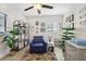 Serene home office with blue armchair, decorative shelves, and potted plants at 946 23Rd S Ave, St Petersburg, FL 33705