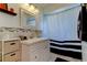 Bathroom with vanity, tub, shower, and black and white decor at 10446 Tara Dr, Riverview, FL 33578