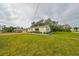 Side view of a renovated house showcasing its landscaping and curb appeal at 1161 Howard St, Clearwater, FL 33756
