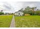 Backyard view of the house, highlighting a fence and side yard at 1161 Howard St, Clearwater, FL 33756