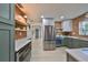 Modern kitchen with green cabinets, quartz countertops and stainless steel appliances at 1161 Howard St, Clearwater, FL 33756