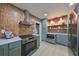 Modern kitchen with green cabinets, stainless steel appliances, and terracotta backsplash at 1161 Howard St, Clearwater, FL 33756
