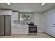 Modern kitchen with stainless steel appliances and white cabinets at 1161 Howard St, Clearwater, FL 33756