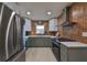 Modern kitchen with green cabinets and stainless steel appliances at 1161 Howard St, Clearwater, FL 33756