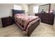 Bedroom with a wooden bed frame and dresser at 12663 Eddington Rd, Spring Hill, FL 34609