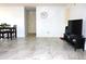 Bright living room with tile floors and a large TV at 12663 Eddington Rd, Spring Hill, FL 34609