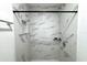 Clean shower with marble tile and built in shelves at 12663 Eddington Rd, Spring Hill, FL 34609