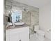 Elegant bathroom featuring a marble sink, mirrored wall, and white toilet at 140 Brightwaters Ne Blvd, St Petersburg, FL 33704