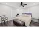 Bedroom with king-size bed, dark hardwood floors, and a comfortable bench at 140 Brightwaters Ne Blvd, St Petersburg, FL 33704