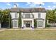 Two story house with white exterior, dark roof and manicured lawn at 140 Brightwaters Ne Blvd, St Petersburg, FL 33704