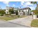 Two-story house with a paved driveway, landscaping, and a white exterior at 140 Brightwaters Ne Blvd, St Petersburg, FL 33704