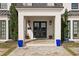 Double front doors and a large porch with blue planters at 140 Brightwaters Ne Blvd, St Petersburg, FL 33704