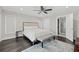 Spacious main bedroom with a king-size bed, dark hardwood floors, and en-suite bathroom at 140 Brightwaters Ne Blvd, St Petersburg, FL 33704