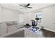 Home office with L-shaped sofa, desk, and large window with water views at 140 Brightwaters Ne Blvd, St Petersburg, FL 33704