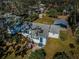 Aerial view of the home with carport, fenced yard and mature trees at 215 35Th Ne Ave, St Petersburg, FL 33704