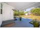 Outdoor deck with gray flooring, overhead cover, and lush tropical foliage in the backyard at 215 35Th Ne Ave, St Petersburg, FL 33704
