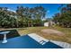 Lush backyard with ample green space and a storage shed, framed by mature trees at 215 35Th Ne Ave, St Petersburg, FL 33704