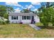Charming single-story home with well-maintained lawn, walkway, and colorful flower accents at 215 35Th Ne Ave, St Petersburg, FL 33704