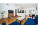 Open-concept living room featuring hardwood floors, white walls, modern lighting, and dining area at 215 35Th Ne Ave, St Petersburg, FL 33704
