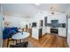 Open-concept living space with vaulted ceiling, hardwood floors, kitchen, and comfortable seating area at 215 35Th Ne Ave, St Petersburg, FL 33704