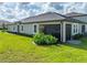 Landscaped backyard with a screened porch at 31500 Magna Gulf Loop, San Antonio, FL 33576