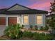 Well-maintained house with a two-car garage and landscaped front yard at 31500 Magna Gulf Loop, San Antonio, FL 33576