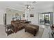 Spacious living room with a leather sofa, ottoman, and access to a patio at 31500 Magna Gulf Loop, San Antonio, FL 33576