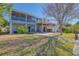 Beautiful backyard with a view of upper and lower decks including a hot tub and manicured lawn at 3295 Hibiscus Dr, Hernando Beach, FL 34607