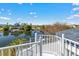 Expansive balcony view overlooking a serene lake, surrounding trees, and neighborhood homes at 3295 Hibiscus Dr, Hernando Beach, FL 34607