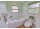Inviting bathroom features a soaking tub, tile surround, and window, providing a serene space at 3295 Hibiscus Dr, Hernando Beach, FL 34607