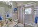 Classic bathroom with a shower-tub combo, and a window providing natural light at 3295 Hibiscus Dr, Hernando Beach, FL 34607