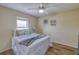 Cozy bedroom with a ceiling fan, wood-look flooring, and a window with natural light at 3295 Hibiscus Dr, Hernando Beach, FL 34607