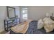 Bright bedroom with wood-look flooring, a window with natural light, and modern furniture at 3295 Hibiscus Dr, Hernando Beach, FL 34607