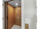 Private residential elevator with paneled wood, carpet floors and a call button panel at 3295 Hibiscus Dr, Hernando Beach, FL 34607