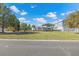 Wide shot showing residence, carport, and additional parking in an expansive, well-maintained yard at 3295 Hibiscus Dr, Hernando Beach, FL 34607