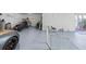 Bright garage with epoxy floor, offering ample space and potential for various uses, featuring a workbench and tool storage at 3295 Hibiscus Dr, Hernando Beach, FL 34607