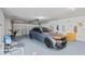 Spacious garage featuring a modern car, painted floors, and organized storage solutions along the back wall at 3295 Hibiscus Dr, Hernando Beach, FL 34607