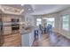 Bright kitchen with granite countertops, stainless steel appliances, and breakfast bar seating at 3295 Hibiscus Dr, Hernando Beach, FL 34607